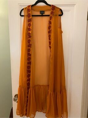 Curations brand long sheer sleeveless cover. Orange with deep red trim